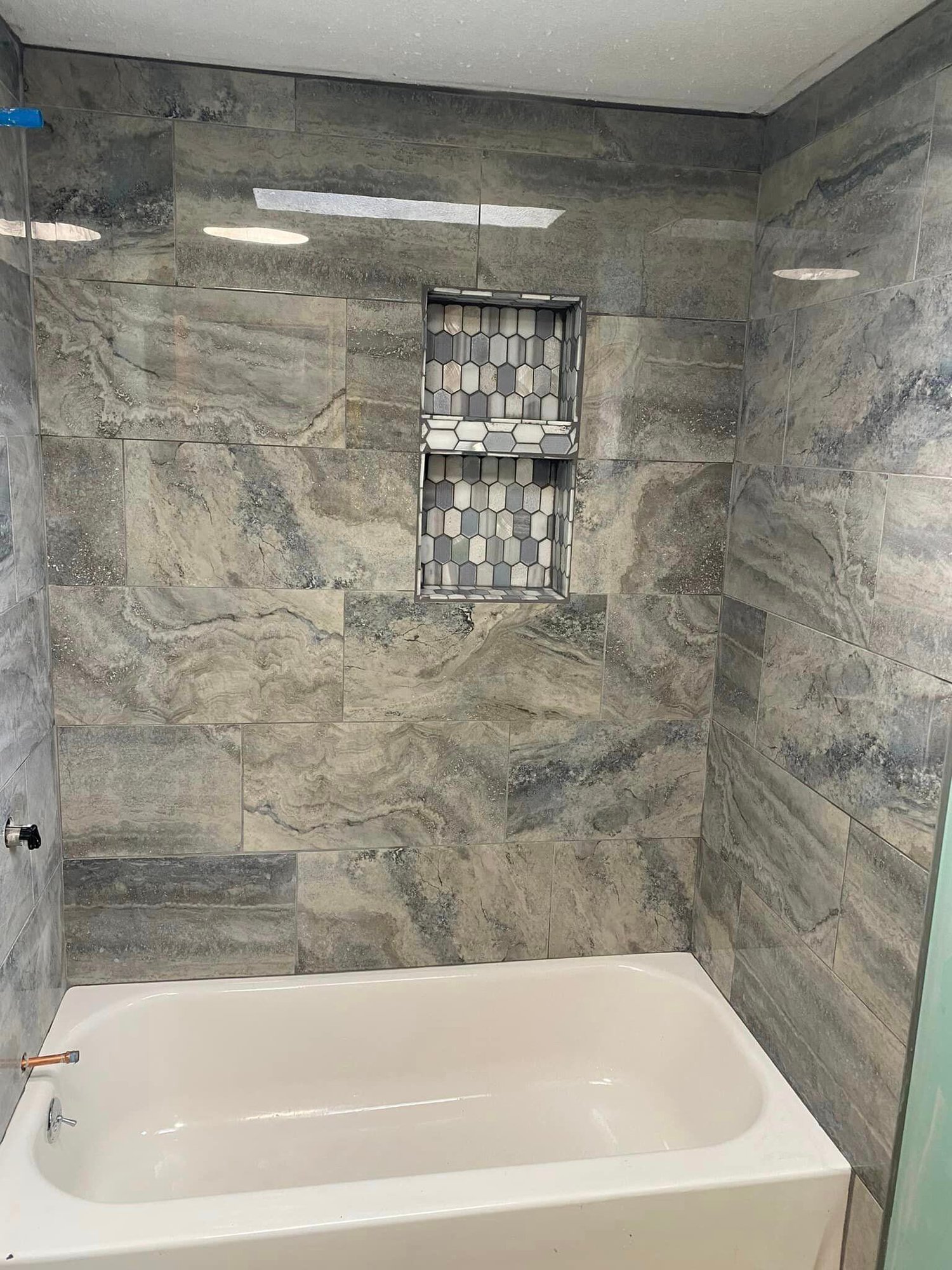 After photo of a bathroom renovation, showcasing new tile and modern fixtures for a fresh, updated look by LLP Home Renovation.